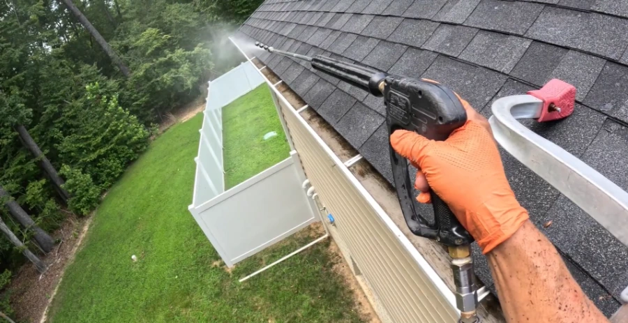 Downspout flush during fall gutter cleaning in Greenville, SC